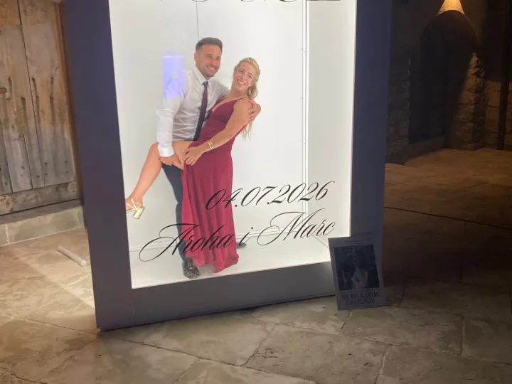 Pareja posando en el photocall Vogue con los nombres en vinilo de corte