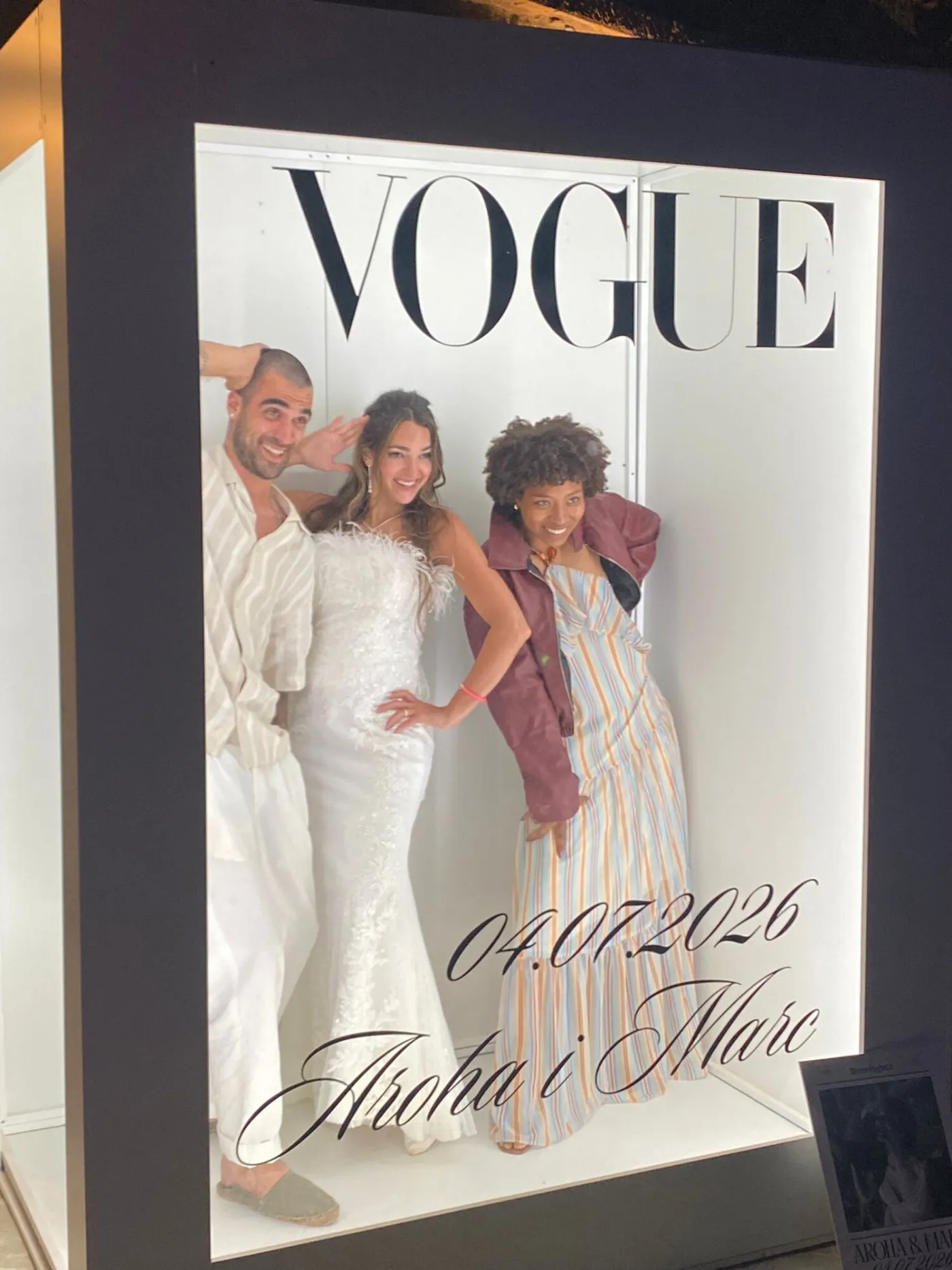 Three guests posing inside the Vogue photocall at a wedding